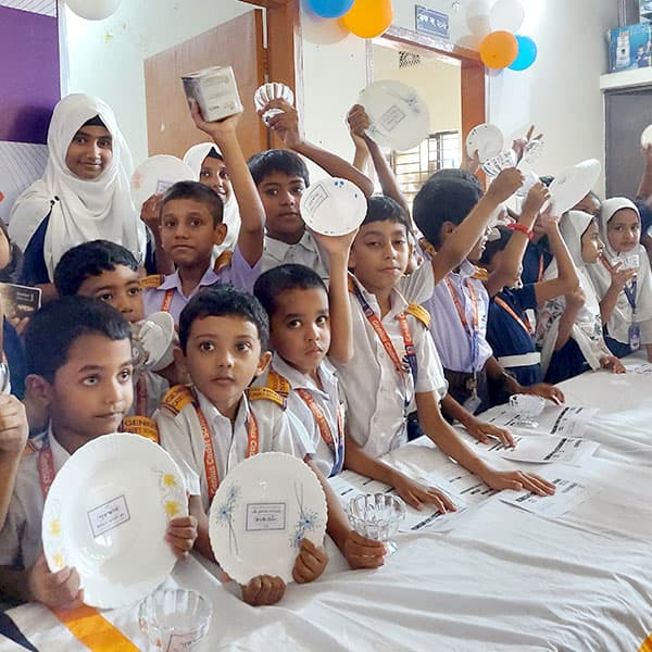 Students raising hands in class